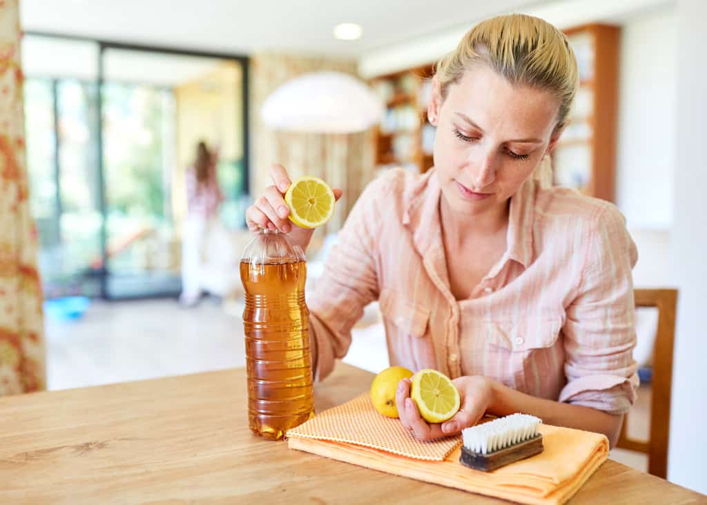 woman making cleaning product with vinegar