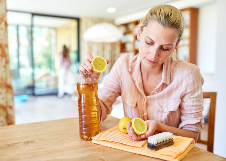 woman making cleaning product with vinegar