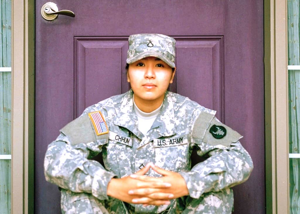 military woman sitting by front door