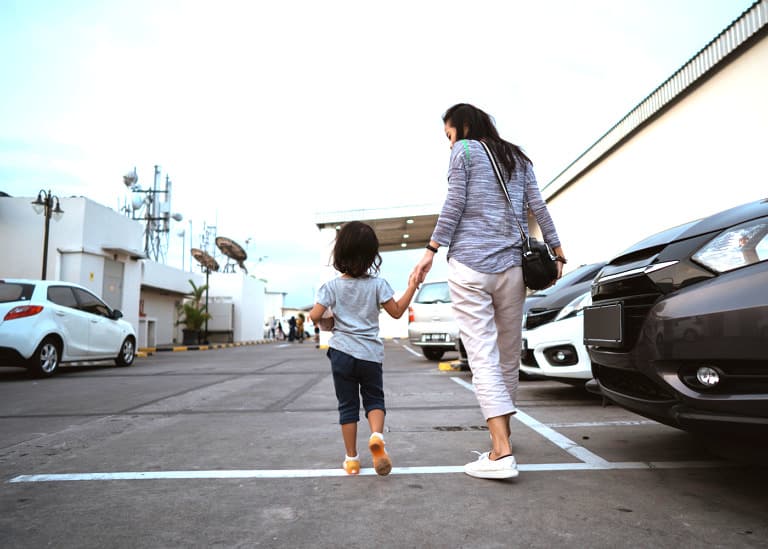 mom and daughter in parking lot
