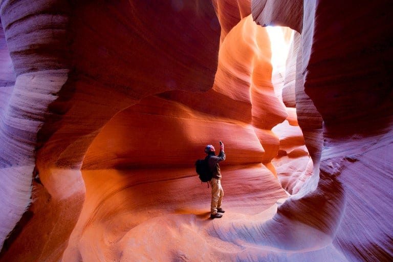 photo of person exploring slot canyons in arizona