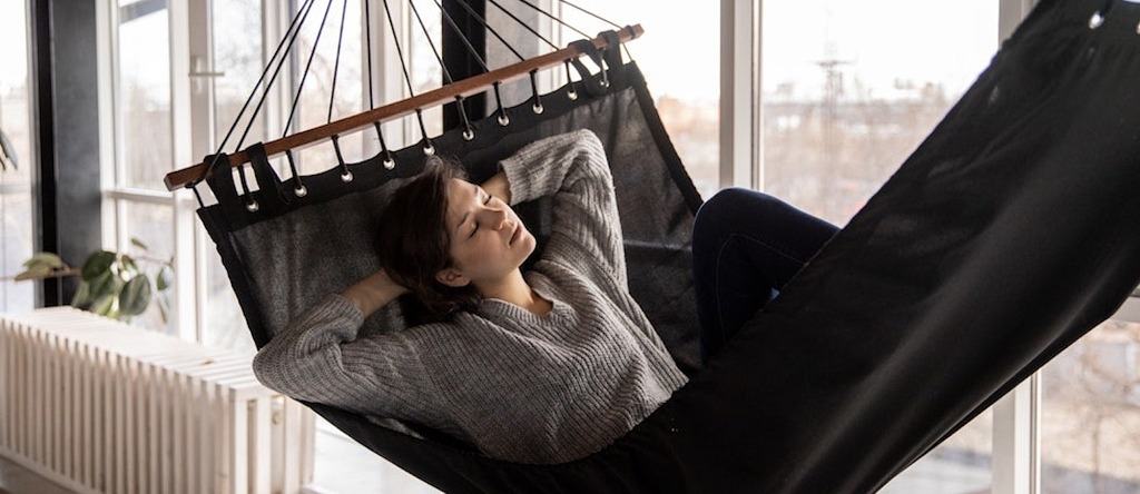 person enjoying an indoor hammock