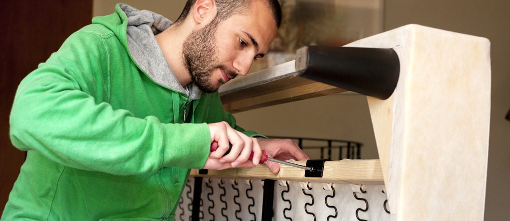 Man taking apart a couch