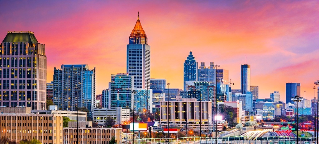 atlanta skyline at night with pink and orange clouds