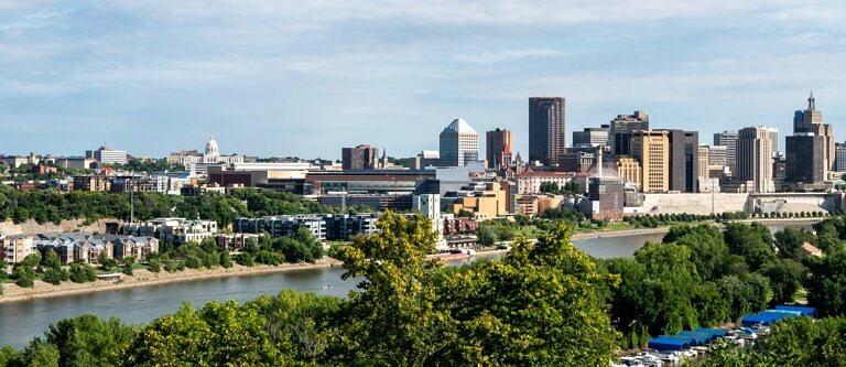 The St. Paul, MN skyline on a bright, partly cloudy day.